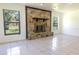 Living room with a large stone fireplace and tile floors at 2508 Providence Rd, Lakeland, FL 33805