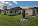 Exterior view of a single-story house with a stone chimney and attached garage at 2508 Providence Rd, Lakeland, FL 33805
