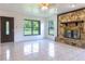 Bright living room featuring a stone fireplace and tile floors at 2508 Providence Rd, Lakeland, FL 33805
