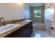 Bathroom with double vanity, granite countertop and tile shower at 2508 Providence Rd, Lakeland, FL 33805