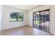 Bedroom with tile floors, window, and sliding door to a screened patio at 2508 Providence Rd, Lakeland, FL 33805