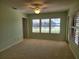 Bedroom with lake view and window shutters at 727 Martinique Cir, Lakeland, FL 33803
