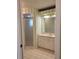 Bathroom with vanity, shower, and striped wallpaper at 727 Martinique Cir, Lakeland, FL 33803
