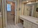 Bathroom with double vanity, toilet, and decorative wallpaper at 727 Martinique Cir, Lakeland, FL 33803