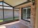 Spacious screened porch with brick flooring and window at 727 Martinique Cir, Lakeland, FL 33803