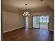 Dining room with hardwood floors and sliding glass doors to sunroom at 727 Martinique Cir, Lakeland, FL 33803
