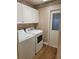 Laundry room with washer, dryer, and cabinets at 727 Martinique Cir, Lakeland, FL 33803