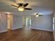 Spacious living room with wood-look floors and ceiling fans at 727 Martinique Cir, Lakeland, FL 33803