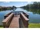 Wooden dock with a small table overlooking a lake at 727 Martinique Cir, Lakeland, FL 33803