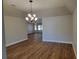 Bright dining room with hardwood floors and elegant chandelier at 727 Martinique Cir, Lakeland, FL 33803