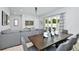 Open concept dining area with dark wood table and gray chairs, adjacent to the living room and kitchen at 7770 Sandy Ridge Dr # 115, Reunion, FL 34747