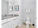 Clean bathroom with white toilet and vanity with gray countertop at 7770 Sandy Ridge Dr # 115, Reunion, FL 34747