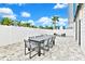 Private backyard patio with dining table, lounge chairs, and modern pavers at 7770 Sandy Ridge Dr # 115, Reunion, FL 34747