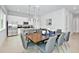 Open concept dining area with dark wood table and gray chairs, next to kitchen at 7770 Sandy Ridge Dr # 115, Reunion, FL 34747