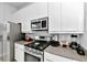 Modern kitchen with stainless steel appliances and white cabinetry at 7770 Sandy Ridge Dr # 115, Reunion, FL 34747