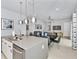 Modern kitchen with stainless steel appliances and an island with seating at 7770 Sandy Ridge Dr # 115, Reunion, FL 34747