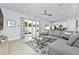 Living room with gray sectional sofa and sliding doors leading to a patio at 7770 Sandy Ridge Dr # 115, Reunion, FL 34747