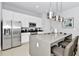 Modern kitchen with stainless steel appliances and an island with seating at 7770 Sandy Ridge Dr # 115, Reunion, FL 34747