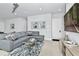 Spacious living room with gray sectional sofa and access to a patio at 7770 Sandy Ridge Dr # 115, Reunion, FL 34747