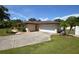 Single-story house with a large yard and a white garage door at 2646 Handley Blvd, Lakeland, FL 33803