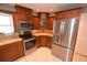 Modern kitchen with stainless steel appliances and wood cabinets at 2646 Handley Blvd, Lakeland, FL 33803