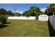 Large backyard with a shed and a white fence at 2646 Handley Blvd, Lakeland, FL 33803