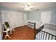 Bright bedroom with wood floors, built-in closet and rocking chair at 2646 Handley Blvd, Lakeland, FL 33803