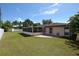 Back of the house with screened patio and landscaping at 2646 Handley Blvd, Lakeland, FL 33803