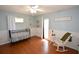Bedroom with crib, rocking chair, and wood floors at 2646 Handley Blvd, Lakeland, FL 33803