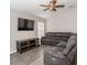 Living room with gray sectional sofa and wood-look floors at 4722 Harts Brook Ln, Mulberry, FL 33860