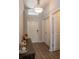 Bright entryway with wood-look floors and coat closet at 4722 Harts Brook Ln, Mulberry, FL 33860