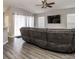 Living room with gray sectional sofa and large TV at 4722 Harts Brook Ln, Mulberry, FL 33860