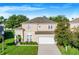 Two-story house with a two-car garage and landscaped yard at 141 Minniehaha Cir, Haines City, FL 33844