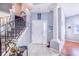 Bright entryway with tiled floors, staircase, and coat rack at 141 Minniehaha Cir, Haines City, FL 33844