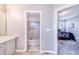 Bathroom with shower, vanity, and access to bedroom and hallway at 141 Minniehaha Cir, Haines City, FL 33844