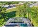 Aerial view showcasing a home's pool and surrounding landscape at 141 Minniehaha Cir, Haines City, FL 33844