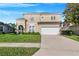 Two-story house with a two-car garage and landscaped yard at 141 Minniehaha Cir, Haines City, FL 33844