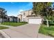 Two-story house with a two-car garage and landscaped yard at 141 Minniehaha Cir, Haines City, FL 33844