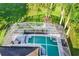Aerial view of a home with a screened pool and spa at 141 Minniehaha Cir, Haines City, FL 33844