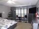 Main bedroom with large bed, desk, and hanging chair at 600 Sunway Ln, Winter Haven, FL 33880