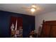 Bedroom with ceiling fan, window coverings, and wood furniture at 600 Sunway Ln, Winter Haven, FL 33880