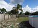 Backyard with above ground pool, partially fenced yard, and palm tree at 600 Sunway Ln, Winter Haven, FL 33880