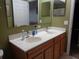 Double sink bathroom vanity with wood cabinets and mirrors at 600 Sunway Ln, Winter Haven, FL 33880