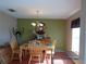 Bright dining room with wood table and chairs, ready for Gathering meals at 600 Sunway Ln, Winter Haven, FL 33880