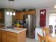 Kitchen boasts stainless steel appliances and wood cabinetry at 600 Sunway Ln, Winter Haven, FL 33880