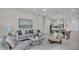 Open living room features a comfortable seating area and flows into the kitchen and dining area at 574 Loblolly Pl, Auburndale, FL 33823