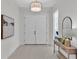 Bright and airy entryway with double doors and a console table at 574 Loblolly Pl, Auburndale, FL 33823