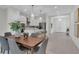 Bright dining area with a wooden table and modern chairs, adjacent to the kitchen at 574 Loblolly Pl, Auburndale, FL 33823