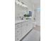 Elegant bathroom with white shaker cabinets and a quartz countertop at 574 Loblolly Pl, Auburndale, FL 33823