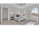 Bedroom with a queen-sized bed, nightstand, and ample natural light at 574 Loblolly Pl, Auburndale, FL 33823